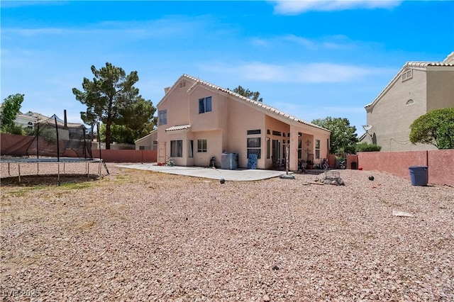2500 Cortina Ave, Henderson, NV 89074 - rear view of property featuring a trampoline, a patio area, and stucco siding