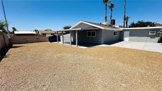 4238 Boratko St, Las Vegas, NV 89115 - back of property with a fenced backyard, a patio, and stucco siding