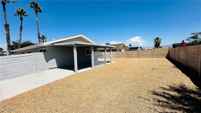 4238 Boratko St, Las Vegas, NV 89115 - rear view of house with a fenced backyard and a patio area