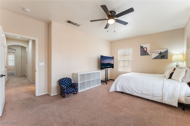 8605 Trianon Ln, Las Vegas, NV 89145 - carpeted bedroom featuring arched walkways, multiple windows, and ceiling fan