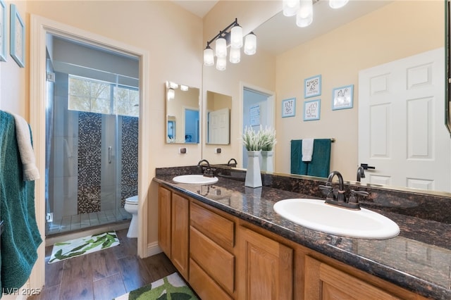 8605 Trianon Ln, Las Vegas, NV 89145 - bathroom featuring double vanity, a shower stall, and wood finished floors