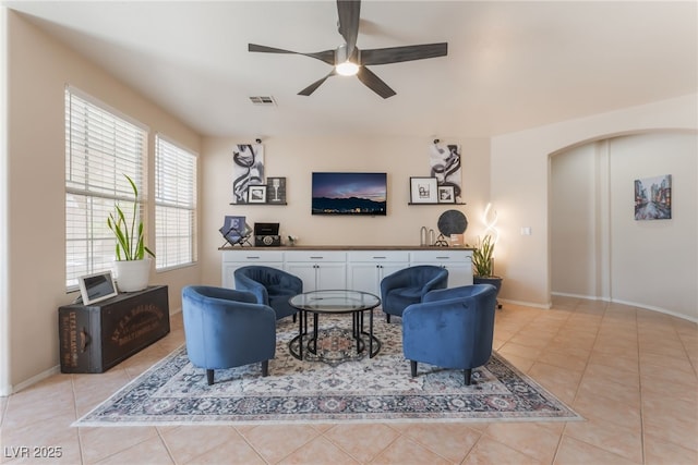 8605 Trianon Ln, Las Vegas, NV 89145 - living room with a ceiling fan, light tile patterned floors, and arched walkways