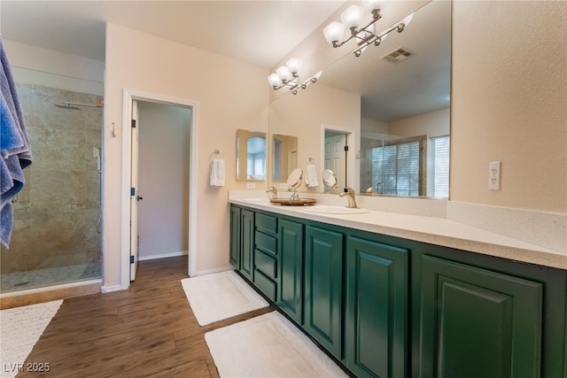 8605 Trianon Ln, Las Vegas, NV 89145 - bathroom with a stall shower, double vanity, and wood finished floors