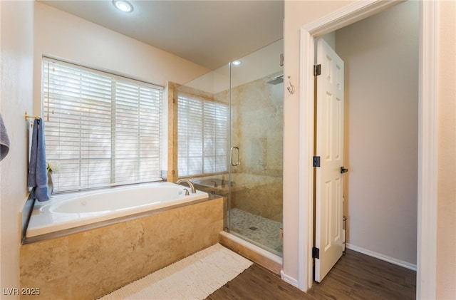 8605 Trianon Ln, Las Vegas, NV 89145 - bathroom featuring wood finished floors, a bath, a stall shower, and recessed lighting