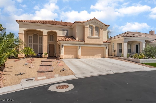 8605 Trianon Ln, Las Vegas, NV 89145 - mediterranean / spanish-style home featuring stucco siding, concrete driveway, an attached garage, and a tile roof