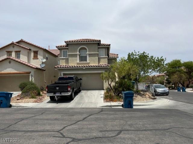 9564 Fresh Crown Ct, Las Vegas, NV 89148 - mediterranean / spanish-style home with concrete driveway, an attached garage, stucco siding, and a tile roof