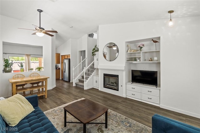 10352 Natural Springs Ave, Las Vegas, NV 89129 - living area featuring ceiling fan, dark wood-type flooring, a glass covered fireplace, and vaulted ceiling
