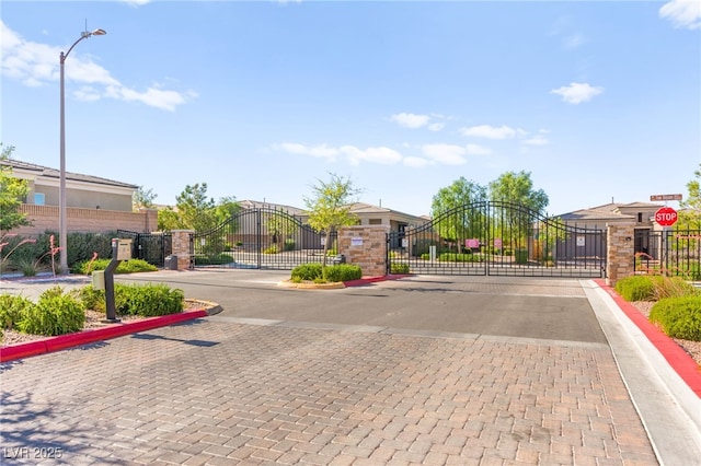 10160 Tree Blossom Ave, Las Vegas, NV 89166 - view of decorative street with a gate, curbs, and a gated entry