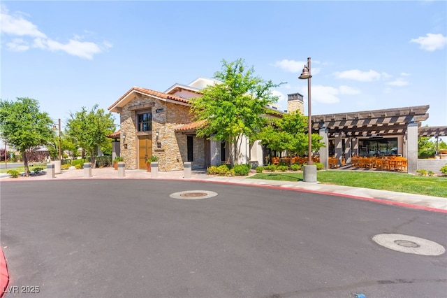 10160 Tree Blossom Ave, Las Vegas, NV 89166 - view of front facade with stone siding and a pergola