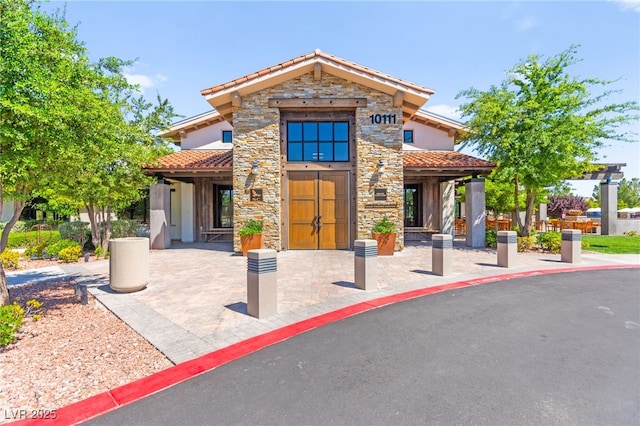 10160 Tree Blossom Ave, Las Vegas, NV 89166 - view of front of property with a tiled roof, stone siding, and stucco siding