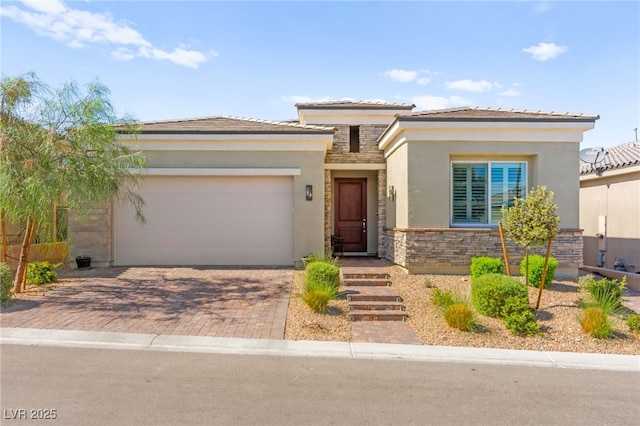 10160 Tree Blossom Ave, Las Vegas, NV 89166 - prairie-style house featuring stone siding, stucco siding, an attached garage, and decorative driveway