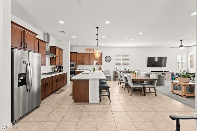 10160 Tree Blossom Ave, Las Vegas, NV 89166 - kitchen with stainless steel appliances, light countertops, recessed lighting, hanging light fixtures, and open floor plan