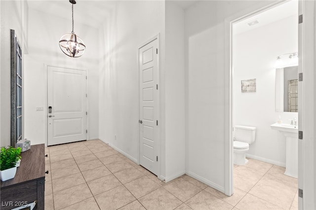 10160 Tree Blossom Ave, Las Vegas, NV 89166 - foyer entrance with a chandelier and light tile patterned flooring