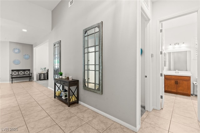 10160 Tree Blossom Ave, Las Vegas, NV 89166 - corridor featuring light tile patterned floors and a sink