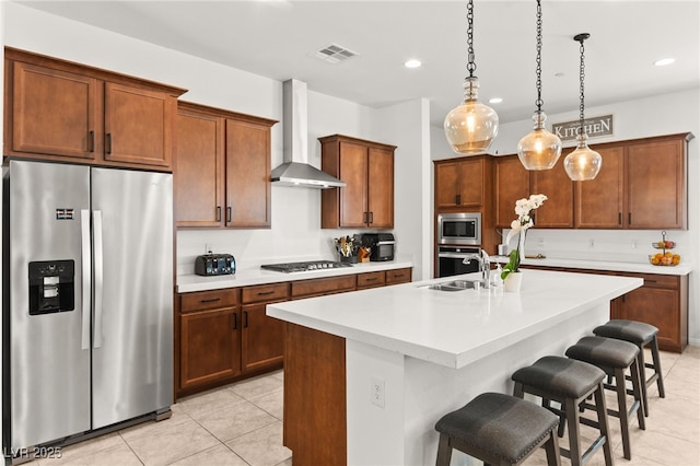10160 Tree Blossom Ave, Las Vegas, NV 89166 - kitchen featuring stainless steel appliances, wall chimney exhaust hood, light tile patterned flooring, a kitchen breakfast bar, and a kitchen island with sink