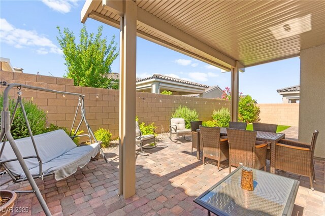 10160 Tree Blossom Ave, Las Vegas, NV 89166 - fenced backyard with outdoor dining area and a patio
