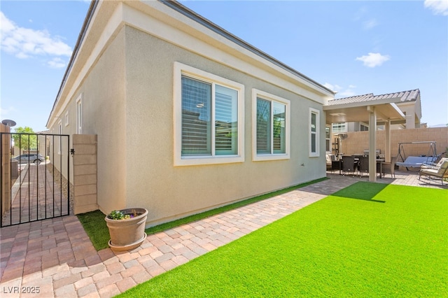 10160 Tree Blossom Ave, Las Vegas, NV 89166 - rear view of property featuring a patio area, a gate, and stucco siding