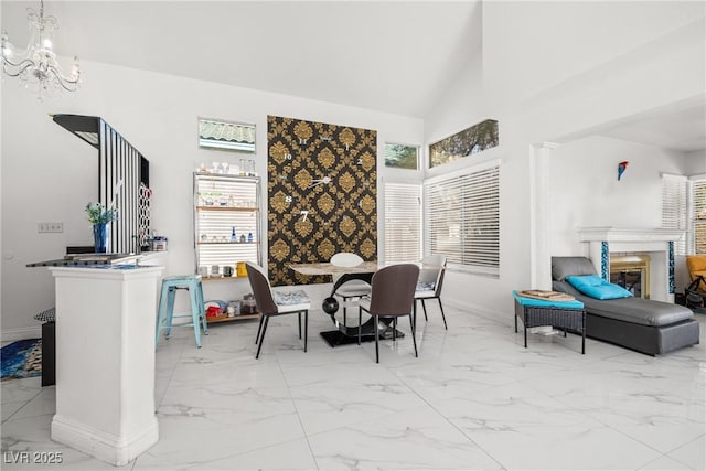 5332 Desert Blossom Rd, Las Vegas, NV 89107 - dining room featuring marble finish floors, healthy amount of natural light, a chandelier, and high vaulted ceiling