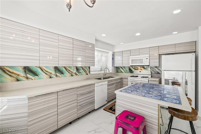 5332 Desert Blossom Rd, Las Vegas, NV 89107 - kitchen with white appliances, modern cabinets, a kitchen breakfast bar, light marble finish flooring, and light countertops