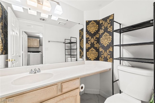 5332 Desert Blossom Rd, Las Vegas, NV 89107 - bathroom with marble finish flooring, vanity, and washer / clothes dryer