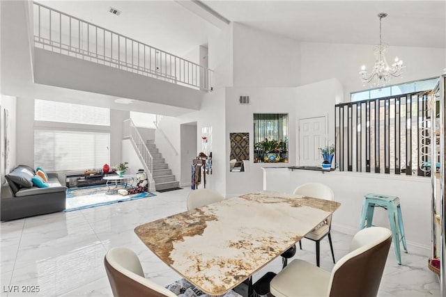 5332 Desert Blossom Rd, Las Vegas, NV 89107 - dining space with marble tiled floors, stairs, a chandelier, and high vaulted ceiling