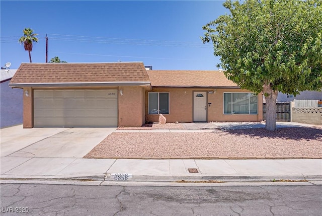 6358 Meadow Lark Ln, Las Vegas, NV 89103 - view of front of home featuring a shingled roof, driveway, a garage, and stucco siding