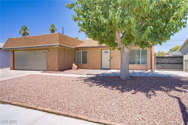6358 Meadow Lark Ln, Las Vegas, NV 89103 - view of front facade featuring an attached garage, stucco siding, and driveway