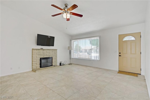 6358 Meadow Lark Ln, Las Vegas, NV 89103 - unfurnished living room featuring healthy amount of natural light, ceiling fan, lofted ceiling, a brick fireplace, and tile patterned floors