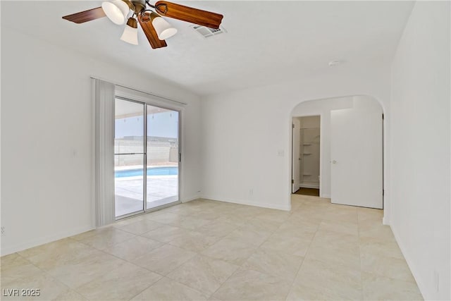 6358 Meadow Lark Ln, Las Vegas, NV 89103 - unfurnished room with arched walkways, ceiling fan, and light tile patterned floors