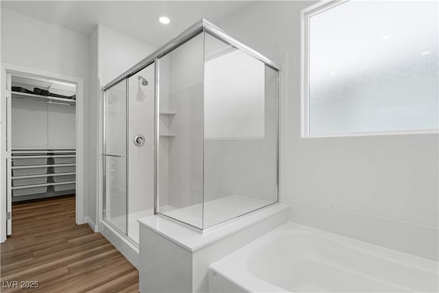 5936 Bruselas St, Las Vegas, NV 89113 - full bathroom featuring a shower stall, a garden tub, a walk in closet, wood finished floors, and recessed lighting