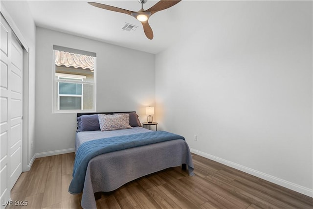 5936 Bruselas St, Las Vegas, NV 89113 - bedroom with wood finished floors, a closet, and ceiling fan
