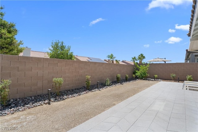 5936 Bruselas St, Las Vegas, NV 89113 - fenced backyard with a patio area