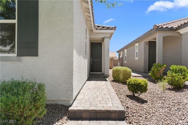 5936 Bruselas St, Las Vegas, NV 89113 - view of exterior entry featuring stucco siding and a tiled roof