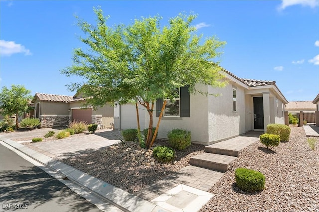 5936 Bruselas St, Las Vegas, NV 89113 - view of front facade with a garage, stucco siding, a tiled roof, and driveway