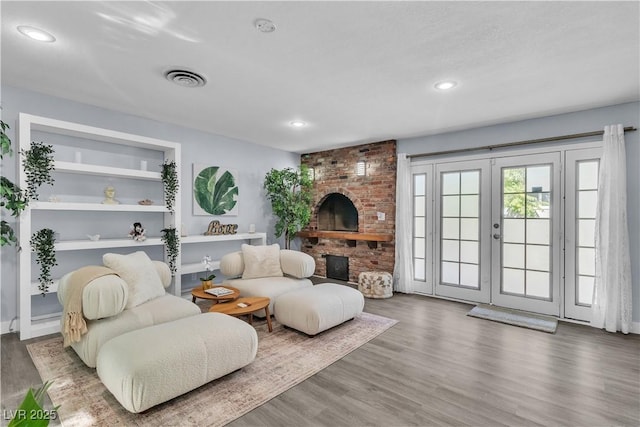 5486 Alfred Dr, Las Vegas, NV 89108 - living room with wood finished floors, recessed lighting, french doors, and a fireplace