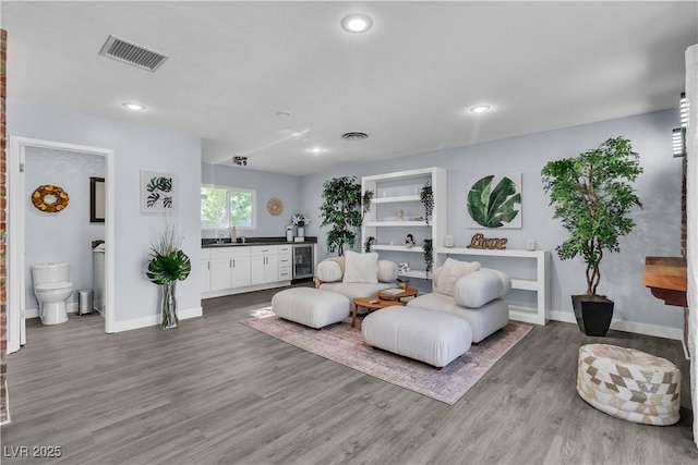 5486 Alfred Dr, Las Vegas, NV 89108 - living area with wine cooler, wood finished floors, and recessed lighting