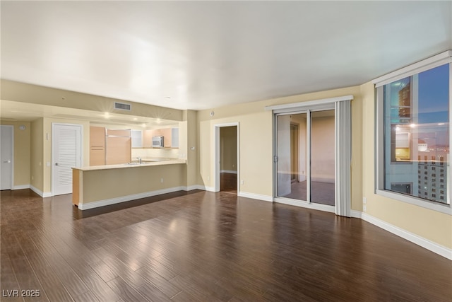 222 Karen Ave Unit 1702, Las Vegas, NV 89109 - unfurnished living room with dark wood-style flooring and baseboards