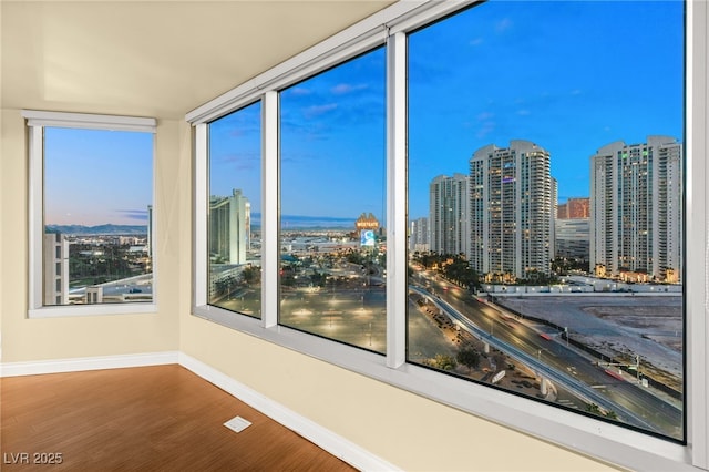 222 Karen Ave Unit 1702, Las Vegas, NV 89109 - spare room featuring a view of city and wood finished floors