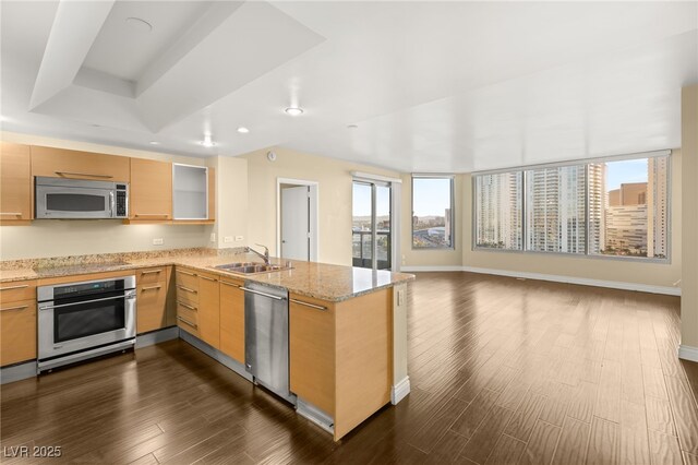 222 Karen Ave Unit 1702, Las Vegas, NV 89109 - kitchen featuring appliances with stainless steel finishes, dark wood-type flooring, a peninsula, recessed lighting, and open floor plan