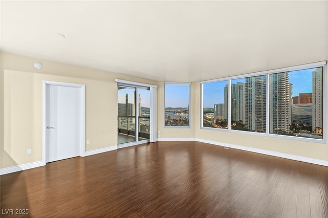 222 Karen Ave Unit 1702, Las Vegas, NV 89109 - empty room with wood finished floors, a city view, and a smoke detector