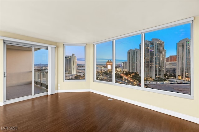 222 Karen Ave Unit 1702, Las Vegas, NV 89109 - spare room featuring wood finished floors and a city view