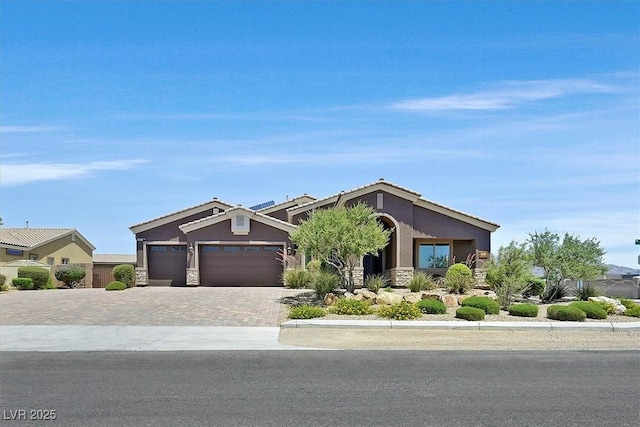 6208 W Rome Blvd, Las Vegas, NV 89131 - view of front of home with stone siding, driveway, stucco siding, and an attached garage