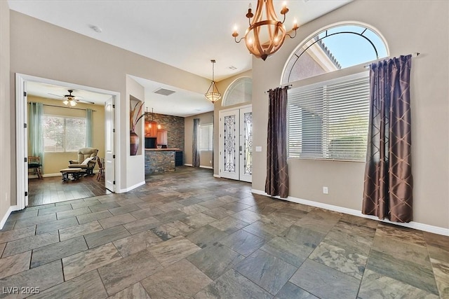 6208 W Rome Blvd, Las Vegas, NV 89131 - unfurnished living room with a chandelier and stone tile flooring