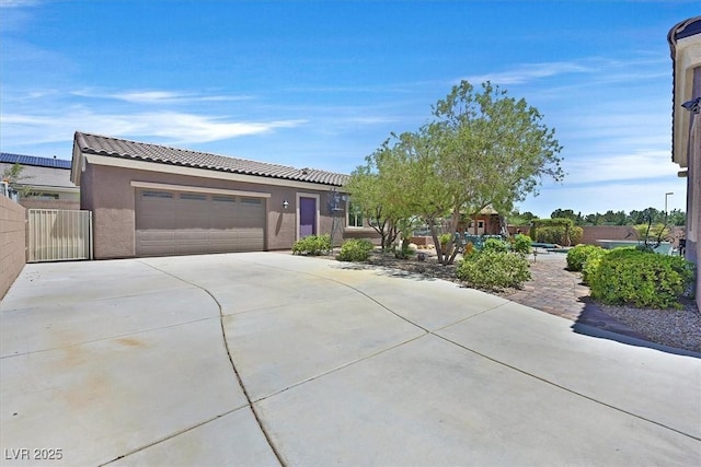 6208 W Rome Blvd, Las Vegas, NV 89131 - view of front of home featuring a tile roof, an attached garage, stucco siding, and concrete driveway