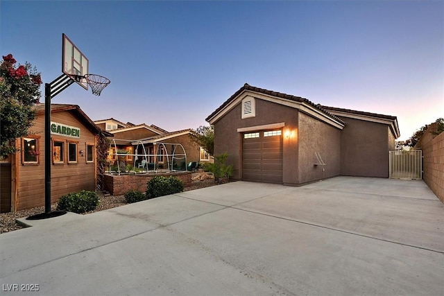 6208 W Rome Blvd, Las Vegas, NV 89131 - view of front facade featuring stucco siding, concrete driveway, and an attached garage