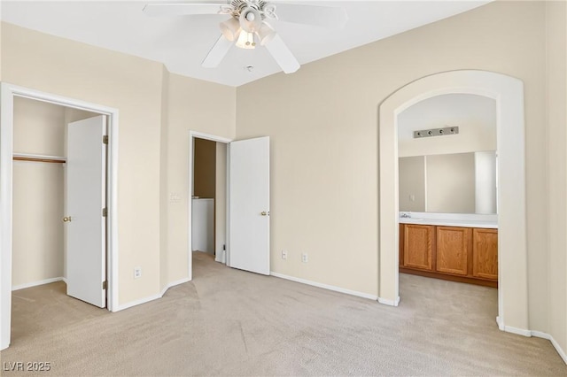 2558 Lazy Saddle Dr, Henderson, NV 89002 - unfurnished bedroom with light colored carpet, ensuite bathroom, a walk in closet, a closet, and a ceiling fan