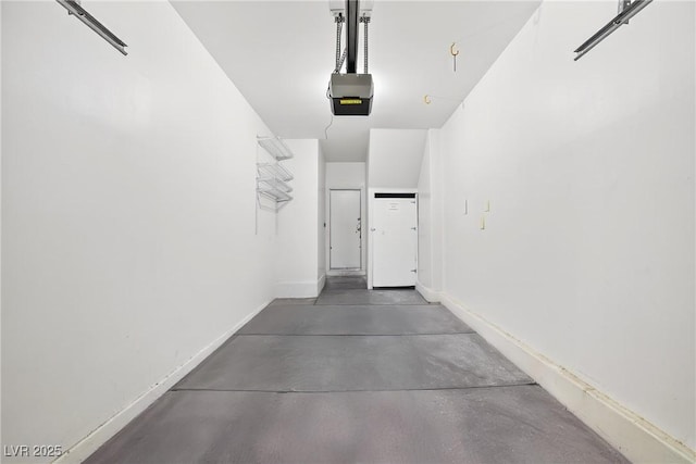 2558 Lazy Saddle Dr, Henderson, NV 89002 - garage featuring a garage door opener and baseboards