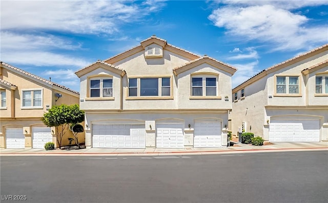 2558 Lazy Saddle Dr, Henderson, NV 89002 - multi unit property with stucco siding, an attached garage, and a tiled roof