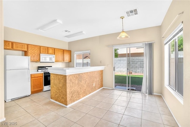 2558 Lazy Saddle Dr, Henderson, NV 89002 - kitchen with white appliances, light countertops, a peninsula, and light tile patterned floors