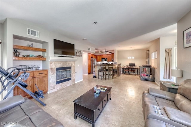 105 Lighthouse Dr Unit 105, Boulder City, NV 89005 - living area with a tiled fireplace, light tile patterned flooring, and built in features